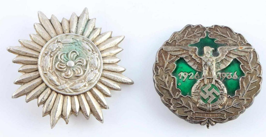 WWII GERMAN EASTERN PEOPLE & GAU BERLIN BADGES: Two badges: Eastern People 'Ostvolk' award, and 1935 Gau Berlin badge with green enamel, thin vertical pin back, and ... Lauer .... Berlin marked to reverse. Good condition. Unauthenticated, sold as i
