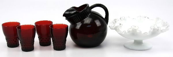 RUBY RED FENTON JUICE PITCHER SET & RUFFLE COMPOTE: Grouping of Fenton glassware including a 6 inch slanted ruby juice pitcher with ice catcher, (4)3.25 inch ruby juice glasses, and a 4x8 inch Fenton ruffled compote. Very good condition.