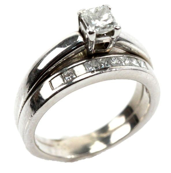 LADIES 14K WHITE GOLD PRINCESS DIAMOND WEDDING SET: Soldered wedding set with an approx. 0.4ct princess cut diamond solitaire in a four-prong setting with a (9) channel set diamond wedding band. Approx. 0.68 ctw. Size: 6.5 Weight: 7.1 g Condition: Very