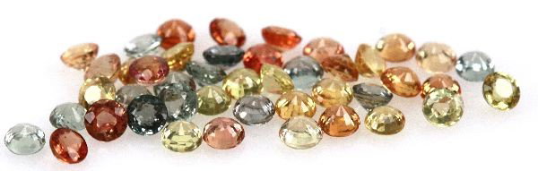 DEALERS LOT OF 8 CTS ROUND CUT FANCY SAPPHIRES: Mixture of yellow, orange, and blue fancy sapphires. Weight: 8.01 cts Condition: Very good
