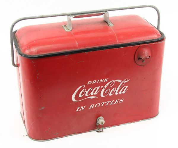 1950'S DRINK COCA-COLA IN BOTTLES AIRLINE COOLER: 18x9.5x11.5 inches. Circa 1950's "Drink Coca-Cola in Bottles" pressed steel airline cooler by Progress Refrigerator Co. of Louisville, Kentucky with screw metal plug and bottle opener. Possibly repain