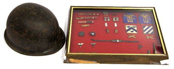 WWII HELMET AND DECORATION ARCHIVE NAMED: WWII Helmet shell, accompanied by a shadow box display case containing patches, bars, and other uniform insignia originally belonging to Lt. James R. Kinsaul. Display case in in need of repair.