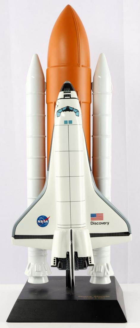 NASA DISCOVERY OV-103 SPACE SHUTTLE MODEL 1/100: NASA Discovery OV-103 space shuttle model. 1/100 scale. Measures approximately 2 feet tall. Base measures 8 3/4 inches wide by 8 3/4 inches long.