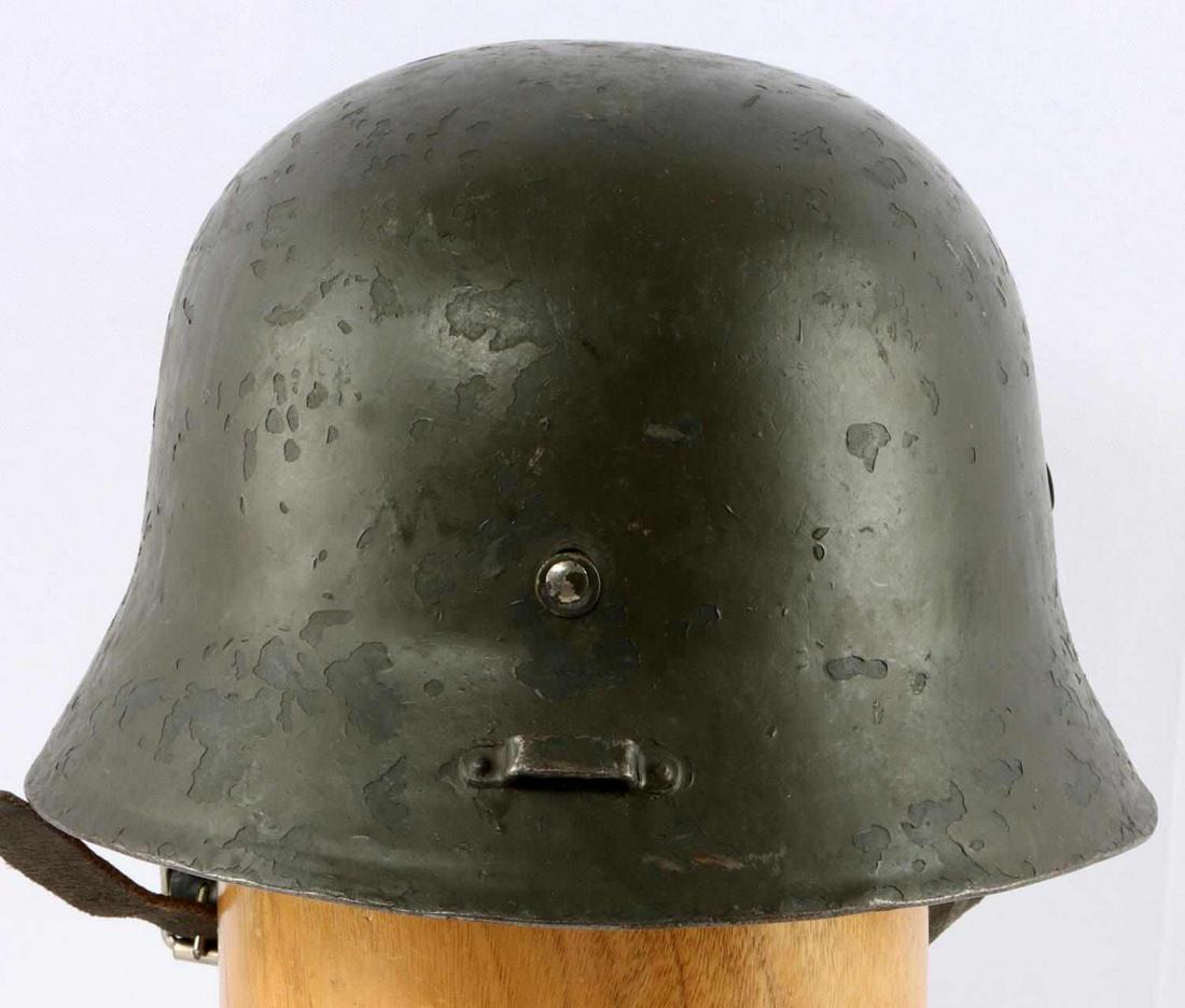 WWII HUNGARIAN M38 HELMET 1940S: Hungarian M38 Helmet. Features interior liners is leather and has ten fingers, marked "57" twice. Also features adjustable chin strap, not marked. Size is small to medium. Light chipping to paint thro