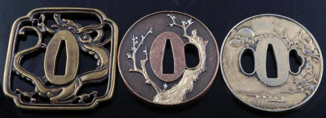 LOT OF 3 BRASS DRAGON COPPER TREE STEEL TSUBA: Solid brass squared tsuba with dragon design, 2.75x3 inches, weighs 102.1 grams.Solid copper circular tsuba with plum tree design. Plum tree is painted gold with silver/white flowers. 2.5 inches in di