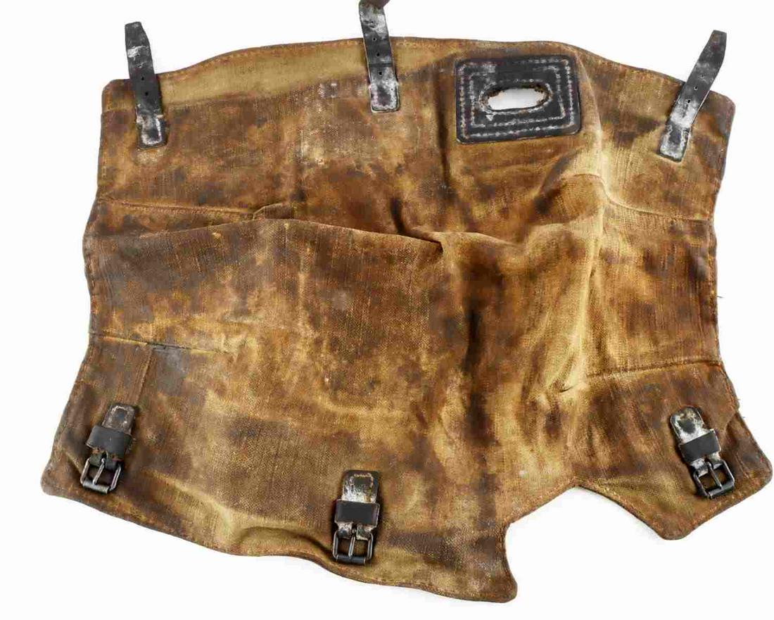 WWII GERMAN THIRD REICH MG34 CANVAS RECEIVER COVER: Canvas construction with leather straps, 20 inches long. Heavy use wear. Stained with gun oil. Good condition.