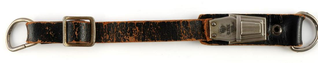 WWII GERMAN SS REICHSFUHRER DAGGER SWORD HANGER: Unusual single leather strapped dagger hanger. Marked SS R.F.S.S. 1939. Push in clasp. Measures 9 inches. Good condition. Unauthenticated, sold as is.