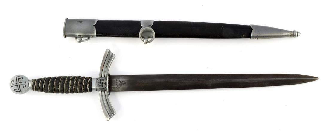 WWII GERMAN 1ST MODEL LUFTWAFFE DAGGER: WWII German 1st model Luftwaffe dagger with scabbard. Zinc fittings with the sunwheel swastika. Navy blue leather handle with twisted wire. SMF Solingen made blade indicated by maker mark. Blade is da