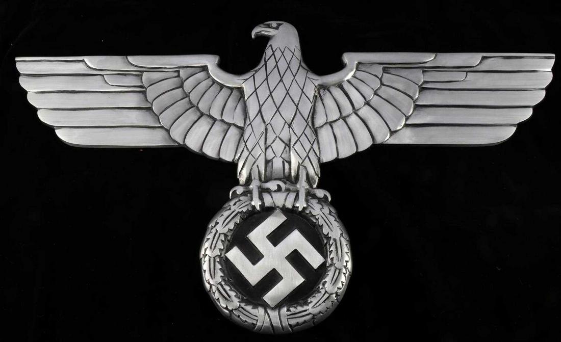 WWII SS ALUMINUM REICHSBAHN RAILWAY EAGLE: Cast aluminum eagle stands on an oak leaf wreath encircling Party symbol. 27.5 inches wide, 15.25 inches tall. Excellent conditon. Unauthenticated, sold as is. This lot has a reserve.