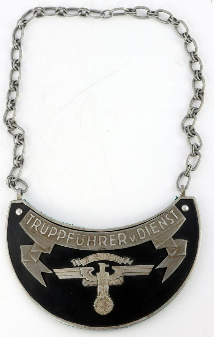 WWII NAZI GERMAN NSKK TRAFFIC EDUCATION SERVICE: Third Reich NSKK traffic education service gorget. Aluminum construction. Felt back. 1 singular prong marked TW and RZM. Chain is non-magnetic. Measures 7 inches. Very good condition. This lot has a r
