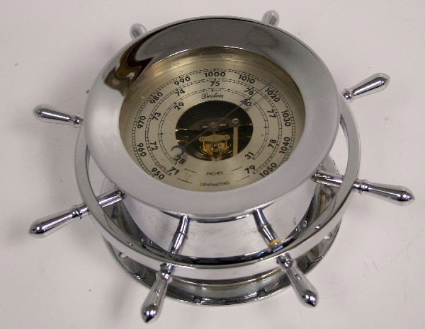 BOSTON SHIPS WHEEL BAROMETER: Boston ship's wheel style barometer. Chrome case, with face measuring 5.5 inches in diameter, and overall 10 inches across shops wheel design. Appears in good condition.