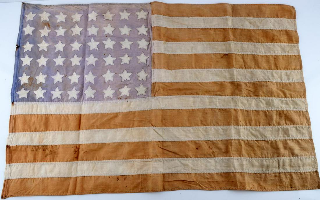 WWII FRENCH LIBERATION 48 STAR AMERICAN FLAG: Hand cut stars sewn into striped flag. Faded from age. Measures approximately 32X21 inches. Very good condition. From Poinconnet, France.