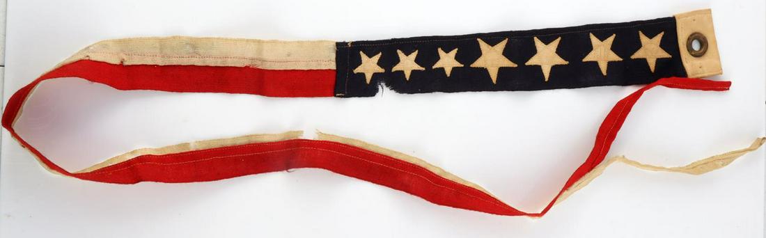 WWI WWII US NAVY COMMISSIONING PENNANT FLAG: White and blue at the hoist, bearing seven white stars, and the rest of the pennant consists of single longitudinal stripes of red and white. Measures 48 inches. Very good condition. Marked Comm. Penn