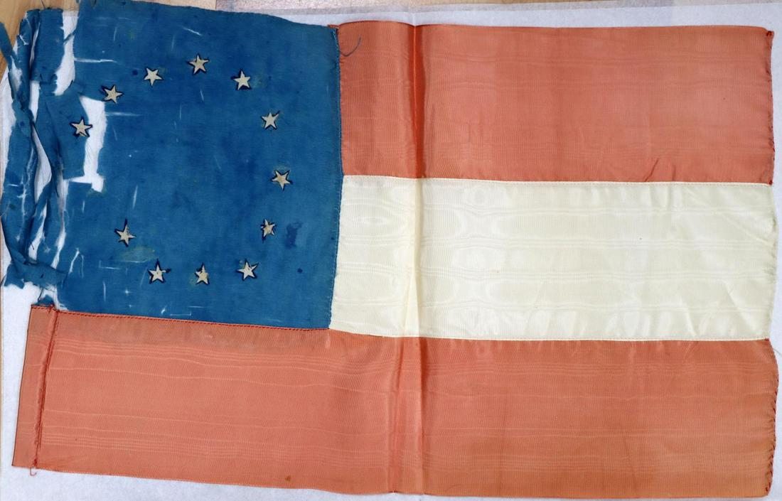 FIRST NATIONAL CONFEDERATE FLAG: Original First National flag, 11 by 17 inches, the star area is frail, and missing star is in separate bag, extremely rare flag from longtime Louisiana collection.