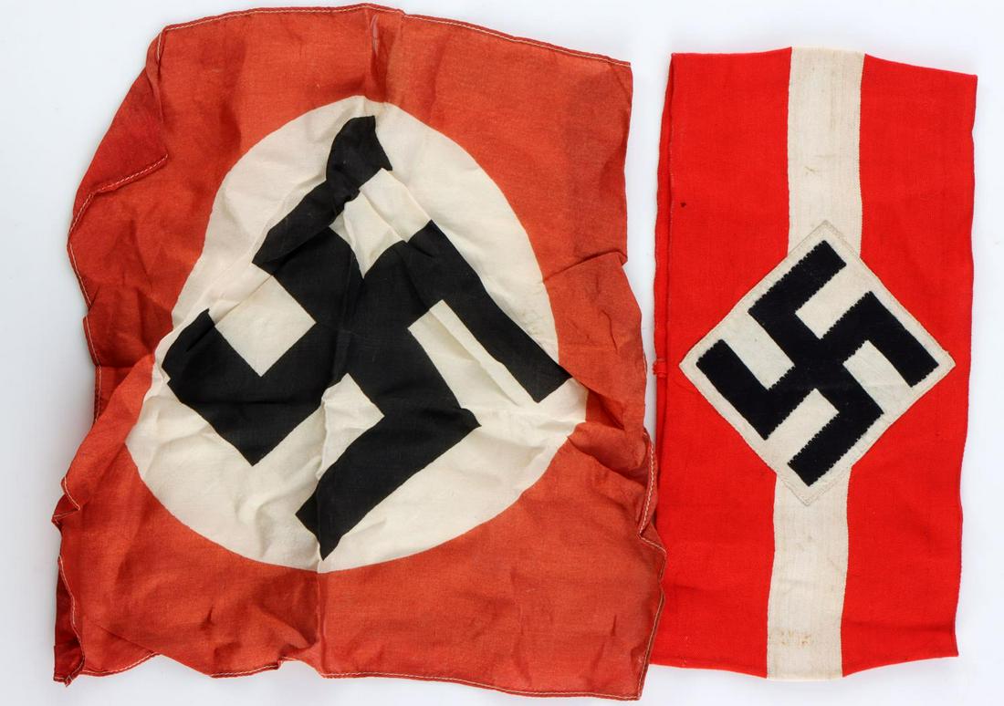 WWII GERMAN THIRD REICH HJ ARMBAND AND TABLE FLAG: Typical Hitlerjugend armband with no tag on interior. Also a silk table flag. Measure 8 1/4 inches. Very good condition with some age wear. Non-fluorescing.