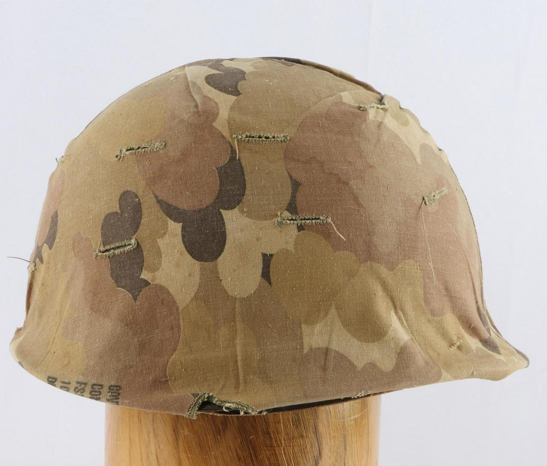 VIETNAM US ARMY M1 COMBAT HELMET W LINER AND COVER: US Vietnam Army Combat Helmet with Camo Cover. The shell is green painted. Includes the fiberglass liner with partial cloth webbing inside. The two bails and chin straps are not present. The exterior 