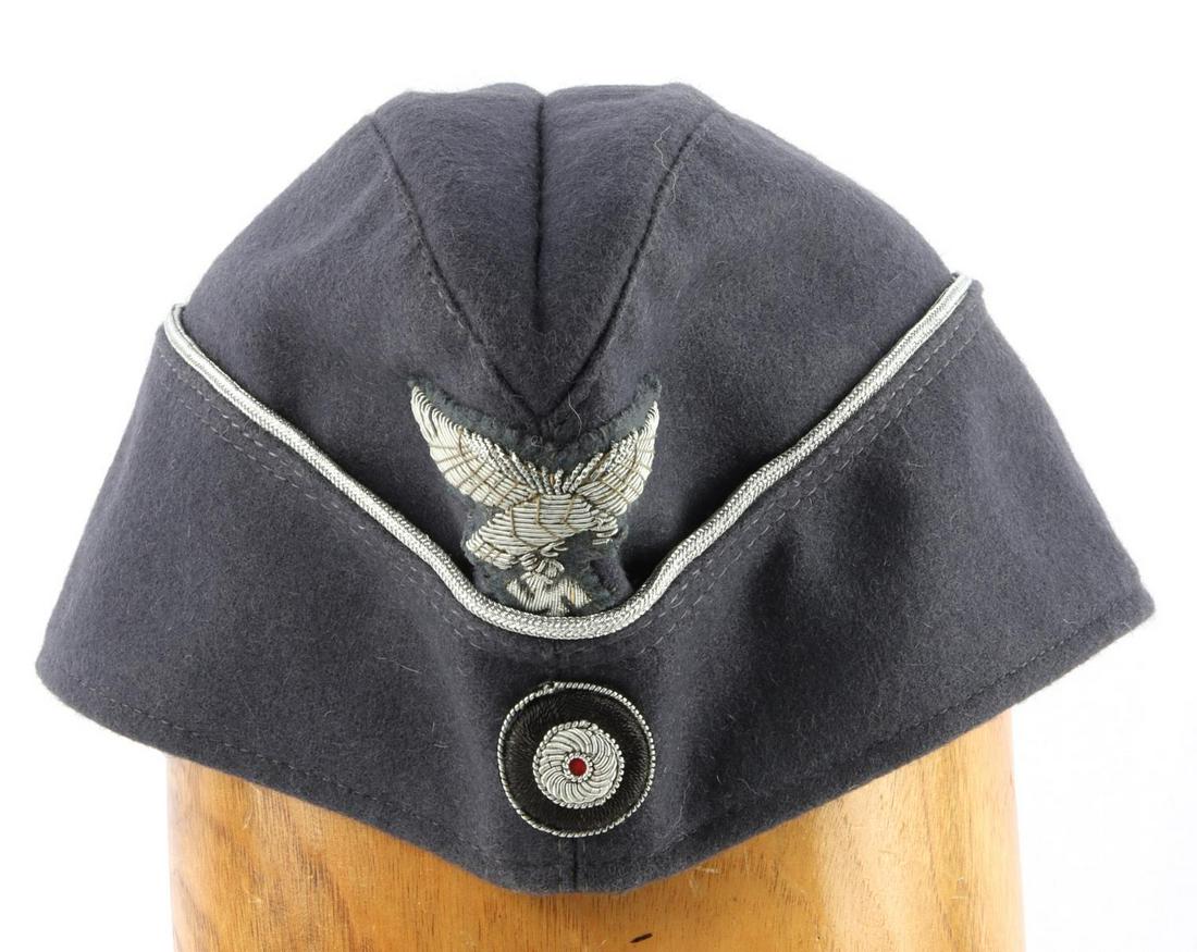 WWII GERMAN THIRD REICH LUFTWAFFE OFFICER CAP: German WWII Luftwaffe Officers Overseas Cap. The body is a dark grey wool blend. There is a silver bullion wire Luftwaffe flying eagle clutching a swastika in his talons sewn onto the front with a bul
