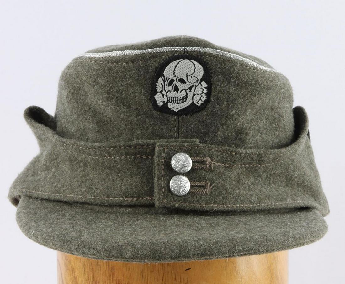 WWII GERMAN THIRD REICH WAFFEN SS OFFICER M43 CAP: German WWII Waffen SS Officers M-43 Cap. The body is an OD green wool. There is a machine embroidered bevo skull and cross bones sewn onto the front. Has a machine embroidered SS eagle sewn on the sid