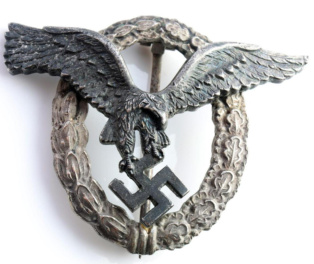 WWII GERMAN LUFTWAFFE PILOTS BADGE: German World War II Luftwaffe Pilot Badge. Measures 2 9/16 X 2 1/16 inches. The front shows a Luftwaffe eagle surrounded by an oval oak leaf wreath. The reverse side of the eagle is maker marked VHCE.