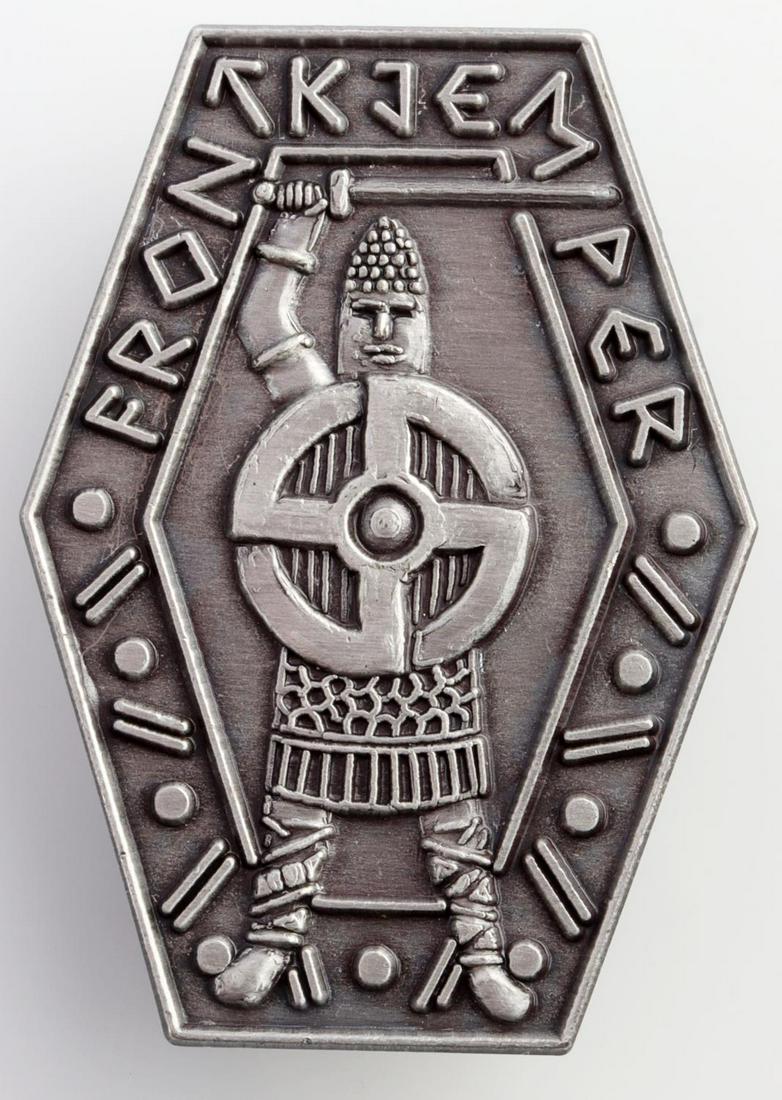 WWII GERMAN FRON KJEM PER SWASTIKA VIKING BADGE: German WWII FRON KJEM PER Swastika Viking Badge. Measures 1 1/8 X 1 1/2 inches. The front reads FRON KJEM PER. There is Viking warrior with a sword in his hand and a cog wheel swastika in the center. 