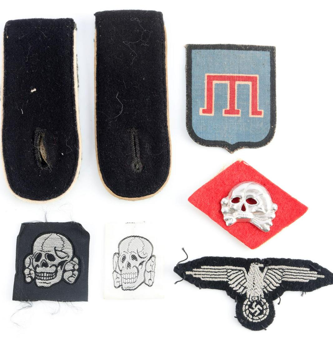 WWII GERMAN THIRD REICH WAFFEN SS INSIGNIA LOT: German WWII Waffen SS Insignia lot includes a Waffen SS enlisted mans arm eagle, pair of SS EM Infantry shoulder boards, two SS bevo SS skulls, early SS metal jawless cap skull, & SS foreign volunteer