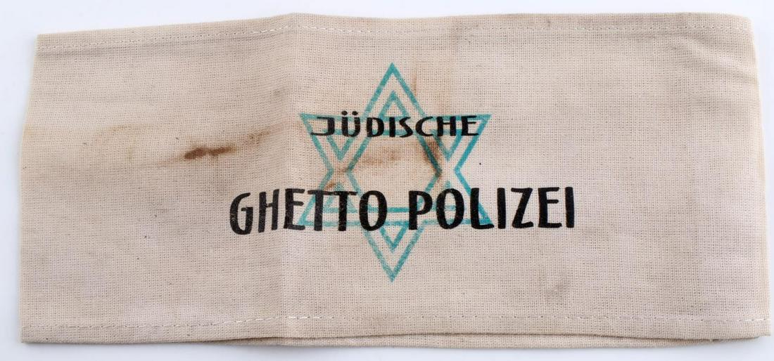 WWII GERMAN THIRD REICH JEWISH POLICE ARMBAND: German WWII Concentration Camp JUDISCHE GHETTO POLIZEI Arm Band. Measures9 1/8” wide by 3 7/8” inches tall. The front reads ‘JUDISCHE GHETTO POLIZEI’. There is a green JewishStar in the back g
