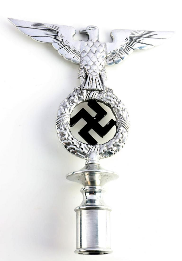 WWII GERMAN NSDAP EAGLE W SWASKTIKA FLAG POLE TOP: German WWII NSDAP political regimental flag pole top. Measures 8 inches wide by 10 5/16 inches tall. Pole top shows eagle with wings spread clutching a wreath of oak leaves and black painted swastika 