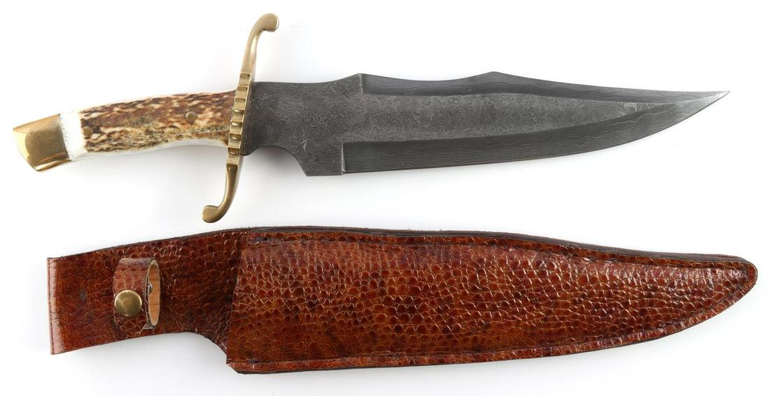 STACKED DAMASCUS BOWIE KNIFE W LEATHER SHEATH: Fox and Hound Bowie knife with layered Damascus blade, brass finger guard, pins and butt. It has stag antler scales and a full Tang. Sheathed in a reptile leather. Both in very good condition. Total l
