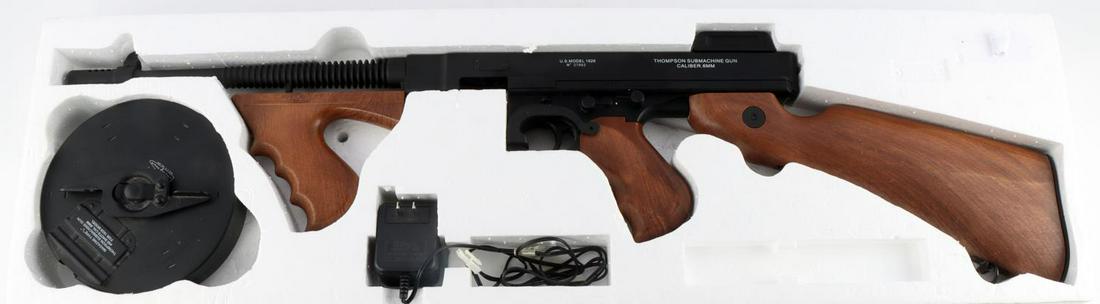 THOMPSON MODEL 1928 .6MM BB MACHINE GUN: New in original box. Soft air plastic .6mm bb gun rifle with a 450 shot magazine. Measures 34 inches overall.