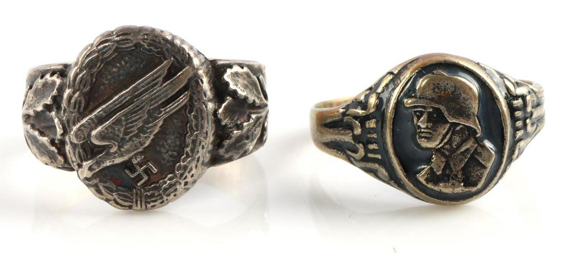 WWII GERMAN THIRD REICH LUFTWAFFE & SOLDIER RINGS: Lot features a Luftwaffe paratrooper badge ring and a ring with a soldier. Luftwaffe ring is marked 800. Very good condition. Sizes 12.5 & 13.