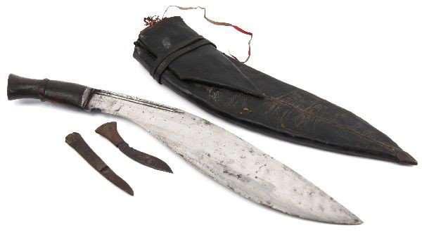 LATE 19TH CENTURY NEPALESE GURKAH KUKRI: Pre 1890 "longleaf" style Gurkha kukri of Nepal. 15 inch curved blade, with lower notch, and Nepalese writing on back of blade. Leather scabbard is complete with karda and chakmak tools, as well as a 