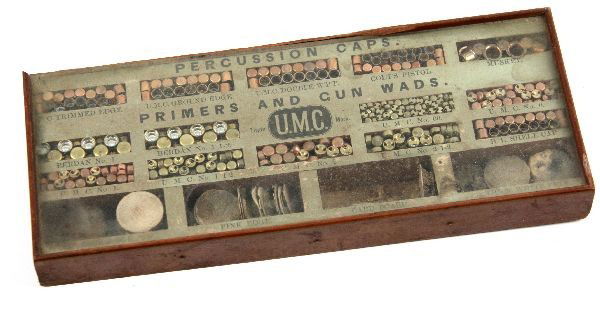 UMC AMMUNITION SALES SAMPLE CAPS PRIMERS & WADS: A vintage sales sample display of percussion caps, primers, and gun wads, for Union Metallic Cartridge Co. (UMC), which merged with Remington in 1912 to create Remington UMC. Samples are displayed in