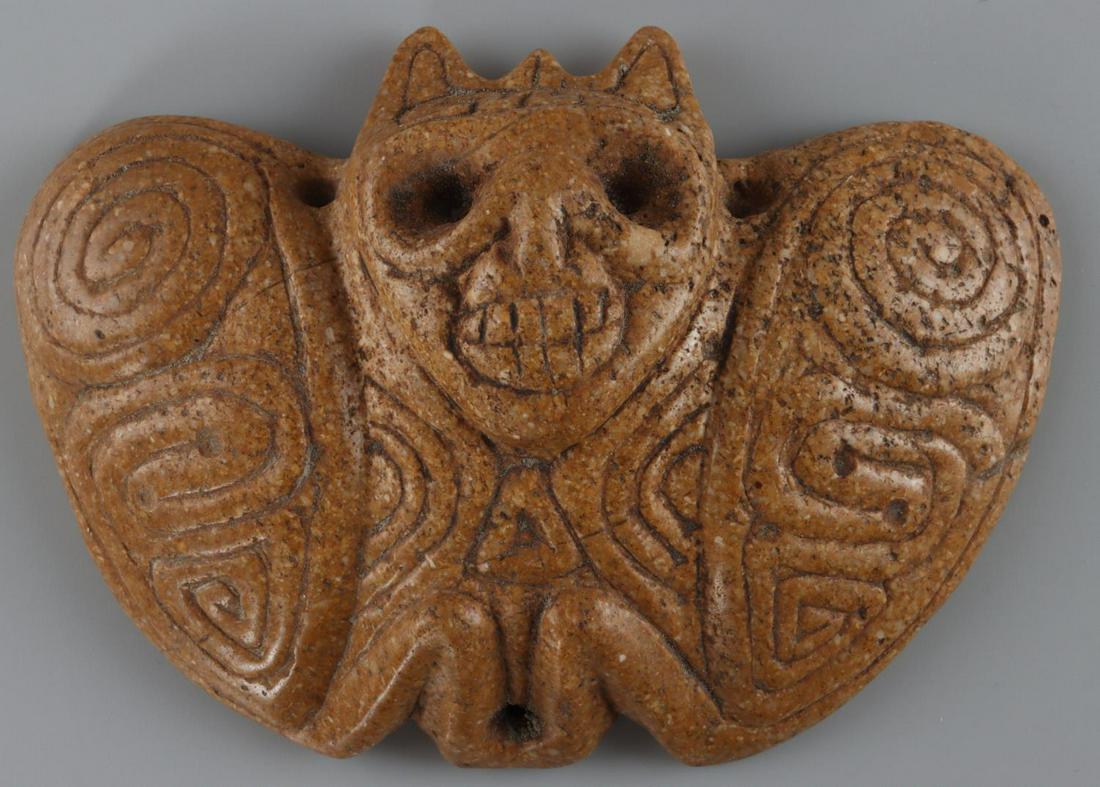 TAINO BAT MEDALLION HEAD WING RELIEF: Taino. Bat medallion. Fully engraved with relief carved head and wings. Deep set eyes and dental display draws ones attention to the medallions imminent presence. It was probably worn during shamanic 