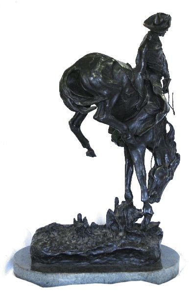 F. REMINGTON BRONZE BRONCO BUSTER: Frederic Remington bronze sculpture "Bronco Buster" on marble base. 22.5 inches tall, 17 inches across base. Features "Copyright of Frederic Remington 57/100" across base. In very good condition.