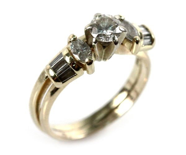 LADIES 14K YELLOW GOLD DIAMOND SOLITAIRE WITH WRAP: Ladies 14K yellow gold approx. 0.56ct solitaire with soldered wrap featuring (2) 0.08ct marquis diamonds and six tapered diamond baguettes. Size: 5.5 Weight: 3.9 g Condition: very good