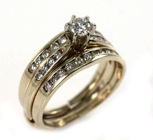 LADIES 14K DIAMOND WEDDING SET: Ladies 14K yellow gold diamond wedding set, 0.8 CTW. Ring features center six prong set round diamond, approx 0.25 ct with eight side channel set diamonds, approx 0.02 cts each; wrap features 20 chann