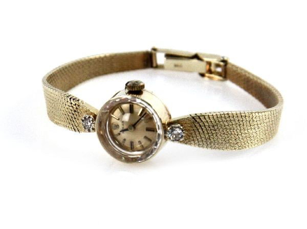 LADIES VINTAGE 14K ROLEX DRESS WATCH: Ladies 14K gold vintage dress Rolex watch with diamond accents. Very good condition with minimal wear considering age, comes with box. Size: 6" Weight: 19.3 g Condition: Very good