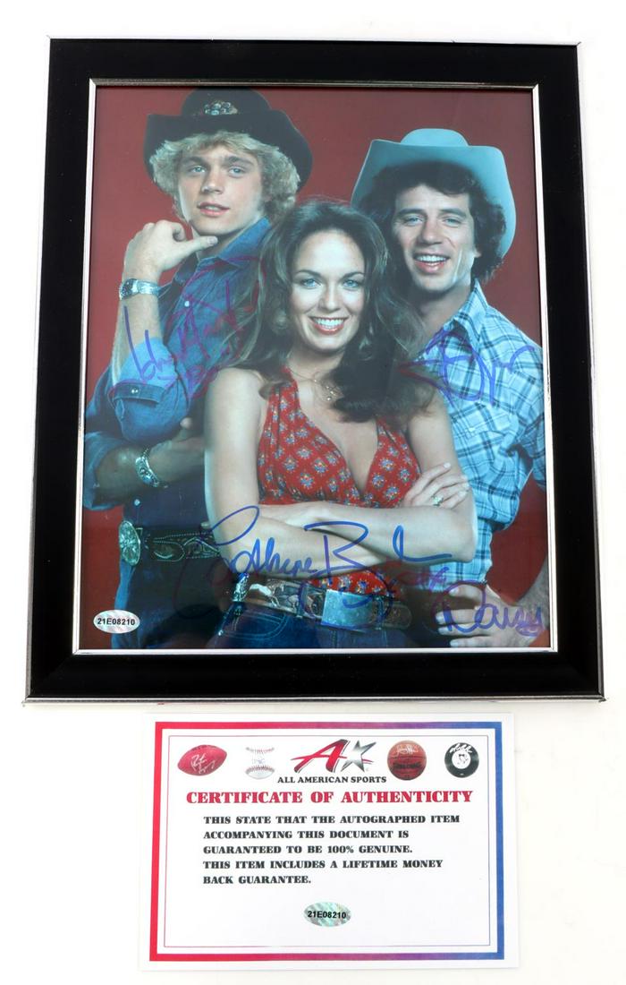 8X10 DUKES OF HAZARD CAST AUTOGRAPHED PHOTO: Dukes of Hazard cast autographed 8X10 photograph. Signed in blue sharpie by John Schneider, Catherine Bach, and Tom Wopat. Includes COA from All American Sports. Unauthenticated, sold as is.