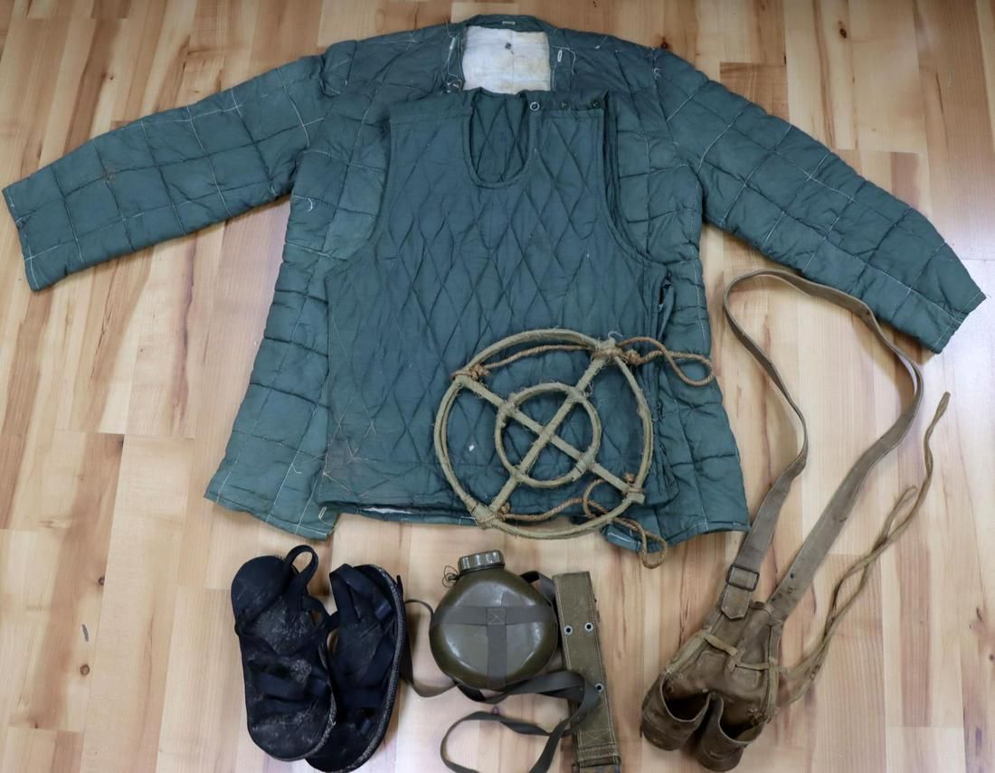 VIET CONG OR NVA VET BRING BACK JACKET GRENADE: Lot features 2 quilted jackets, a pair of shoes made from tires, belt and buckle, grenade pouch, a camouflage foliage loop, and a canteen. Very good condition. This lot has a reserve.