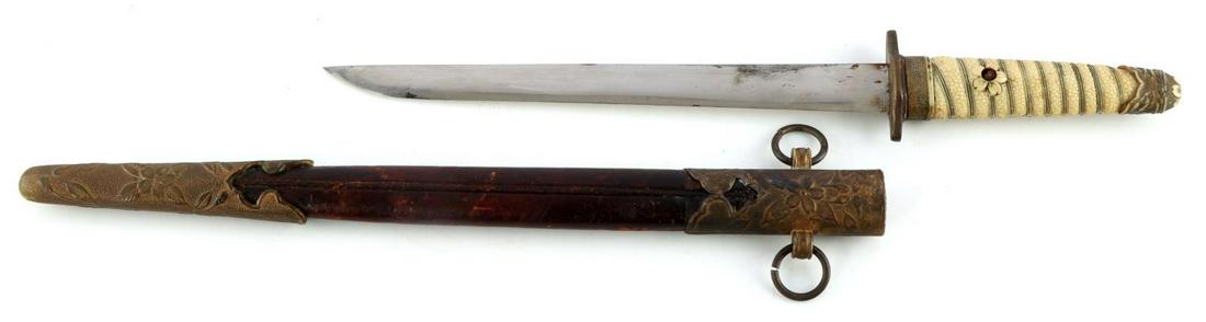 WWII IMPERIAL JAPANESE DAGGER WITH SCABBARD: WWII Imperial Japanese dagger with scabbard. Celluloid pebble designed grip with floral designs. Cannot separate grip from tang. Brass crossguard. Sharp blade with some oxidation. Brown leather scabba