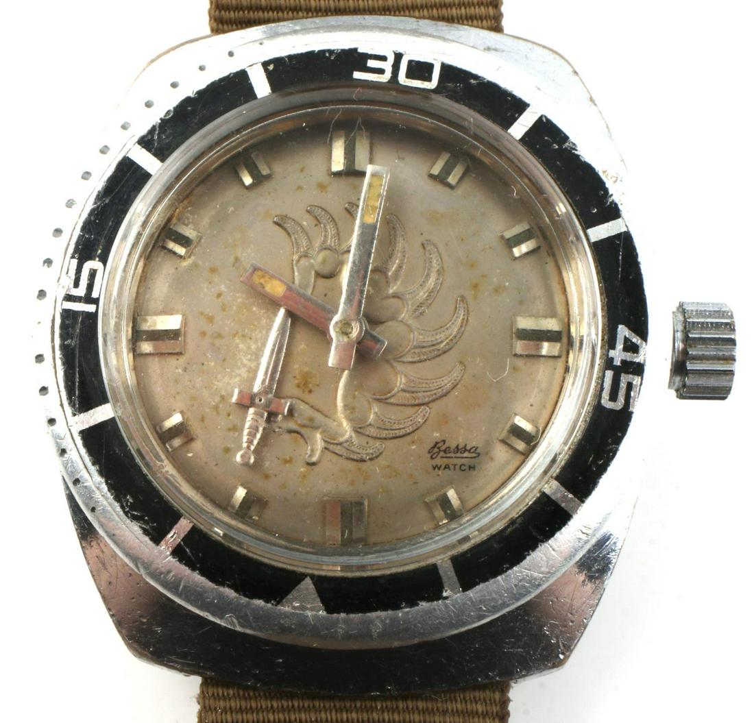BESSA FRENCH FOREIGN LEGION DIVER WATCH: Bessa Watch, self winding, stylized Hubert on face, verso is frogman, and knife is second hand. Works and keeps time. Military band. Heavily used but rare. Measures 48 mm.