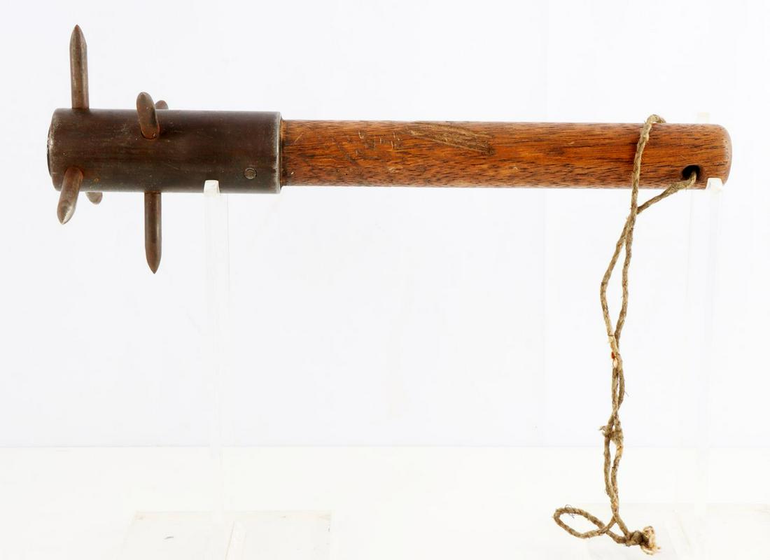 WWI SPIKED TRENCH CLUB W INFANTRY DISC: Rare trench made spiked club, well crafted and meant for business, crossed infantry rifles over G collar disc imbedded on top, measures 12 inches, with original hemp cord. This lot has a reserve.