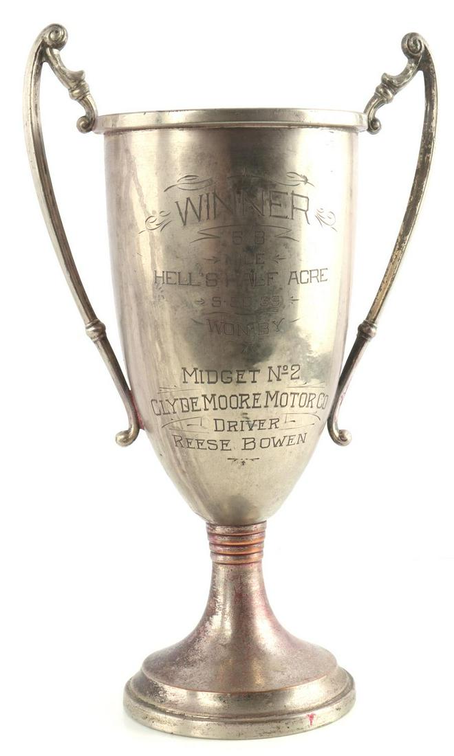 1939 HELLS HALF ACRE TROPHY CLYDE MOORE MOTOR CO.: Inscription reads "1939 Hell's Half Acre 5/8 Mile Trophy Won by Midget N2 Clyde Moore Motor co. Driver Reese Bowen." Hells Half Acre Speedway opened in 1939 as a 1 mile dirt oval speedway. The life of