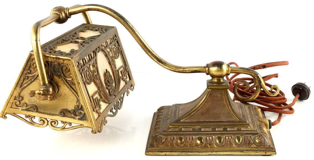 ARTS AND CRAFTS ERA ANTIQUE SLAG GLASS PIANO LAMP: Antique gilt bronze piano lamp. Unidentified maker. Base plate bears a flower and the number 300. In working condition with slag glass fully intact, gilt finish has wear to the high points, and the cl