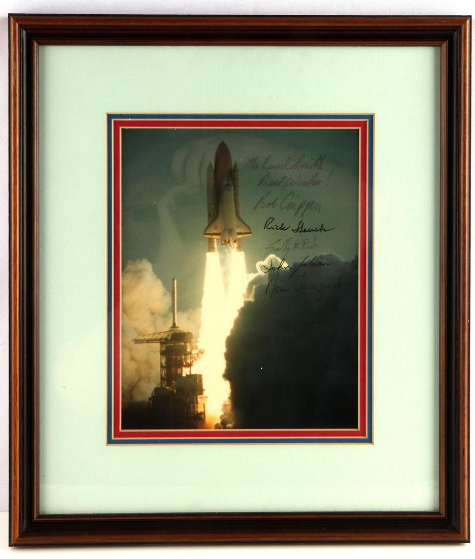 CHALLENGER SHUTTLE CREW SIGNED PHOTO SALLY RIDE: Signed by the 6 crew members of Challenger mission June 1983 "To Russel Smith" signed by crew including Sally K. Ride, Norm Thagard and 4 others, frame measures 16 by 14, photo is 9 by 11 inches. Guar