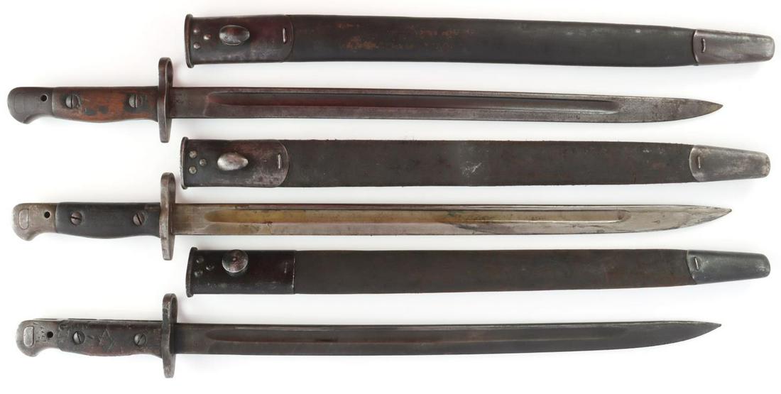 LOT OF THREE 1907 BRITISH REMINGTON BAYONETS: All in sheaths with proof markings all throughout. Blades in good condition, two marked "Wilkinson". Handles are bruised. One handle has 6 pointed star carved into it.
