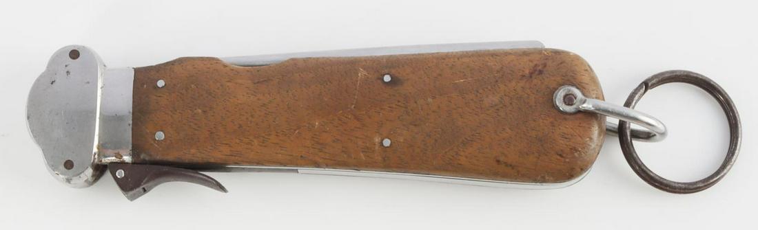 WWII GERMAN REICH FALLSHIRMJAGER GRAVITY KNIFE: WWII German Reich Fallshirmjager paratrooper gravity knife with blade measuring 3 1/8 inches long and is marked "SMF Solingen Rostfrei," blade has been sharpened. Wood grips in good condition. Unauthe