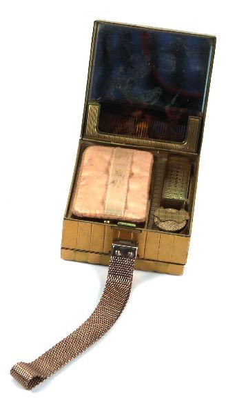 VINTAGE EVANS METAL CLUTCH WITH COMPACT: Evans metal clutch. Opens on either side. One side features a mirror, a comb, a compact, and a built in lipstick case. The other features a cigarette holder (complete with vintage cigarette) and a lig