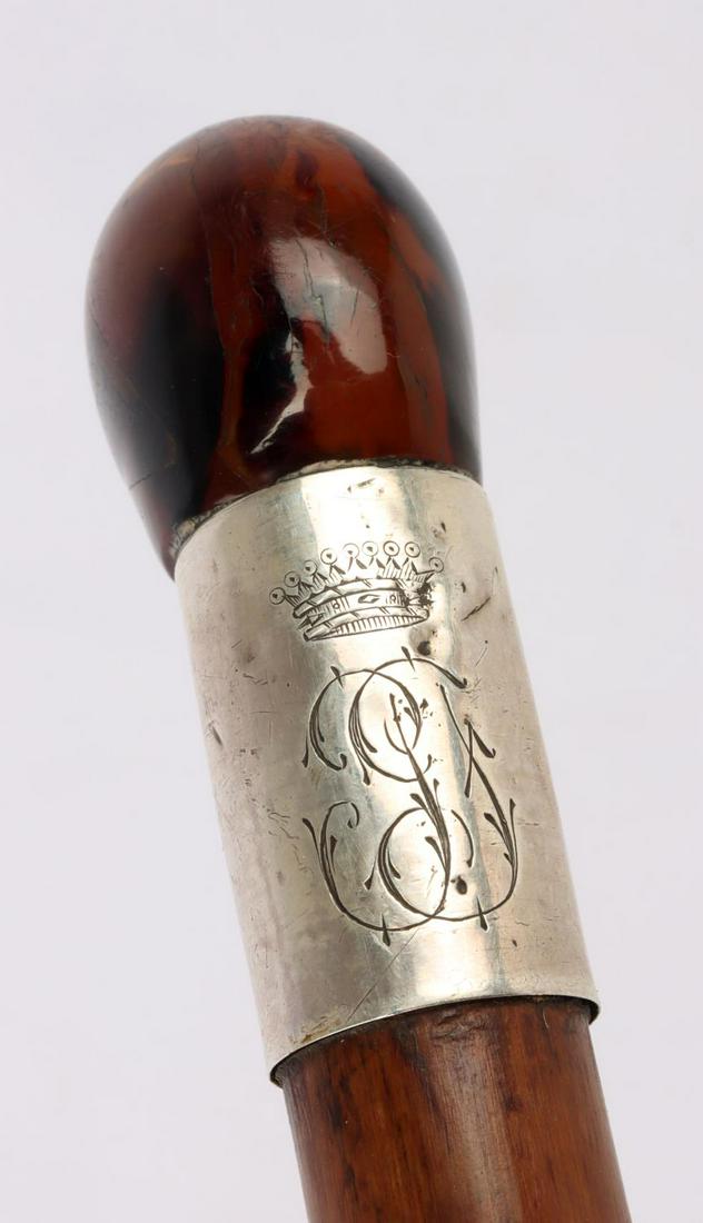 ANTIQUE SWORD DAGGER CANE WALKING STICK: Features an amber pommel, silver wrap with livery crown, brass and metal ferrule tip, and staggered wood shaft. Sword is a straight pull, no push button. Blade measures 13 inches, with grip 18 1/2 inc