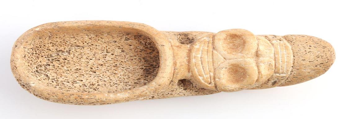 TAINO SPOON WITH SMILING HUMAN FACE CARVING: Taino spoon or ladle. A Smiling human-like face greets the viewer. When inverted a second zoomorphic face appears. The deep bowl suggests this may have been a small ladle rather than a spoon. Possibly
